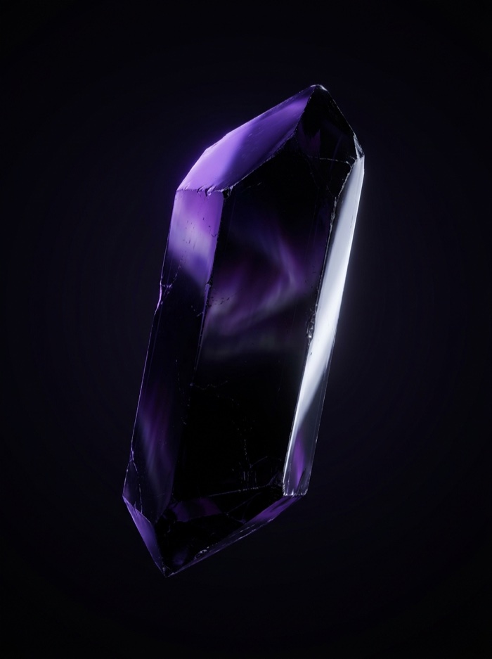 Black obsidian crystal lit by violet aurora light